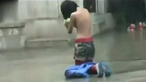 Cô gái ngực trần xin ăn trong mưa 